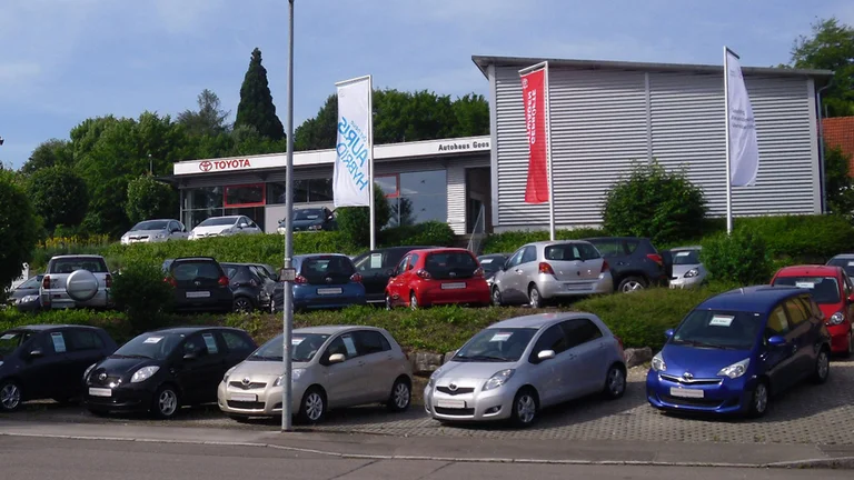 Innenansicht des Autohaus Goos in Nürtingen. Darin befinden sich Sitzgelegenheiten und Vorschau Autos